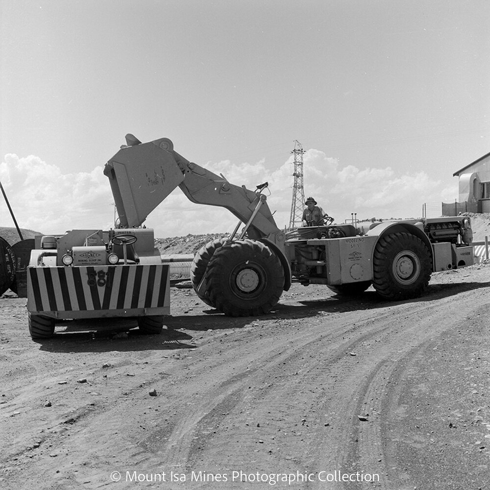 Loader and mining truck at acceptance test, Mount Isa Mines, October 1964