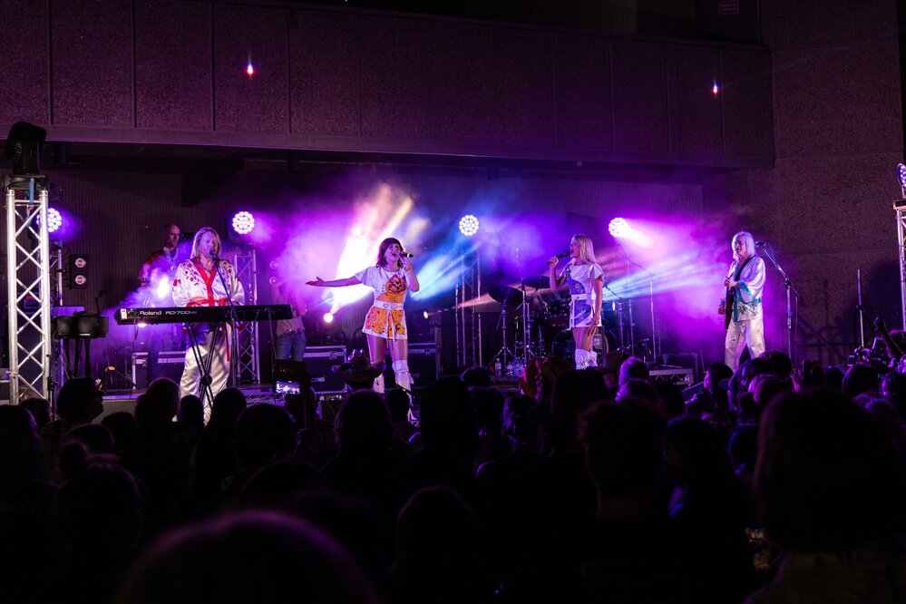 Bjorn Again singing on stage, Isa Street Festival, August 2023