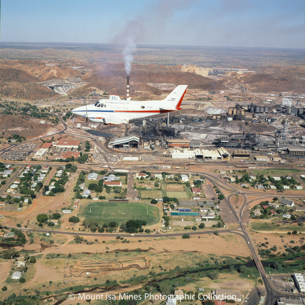 Flying Doctor plane flying south past the Copper Stack, c.1980