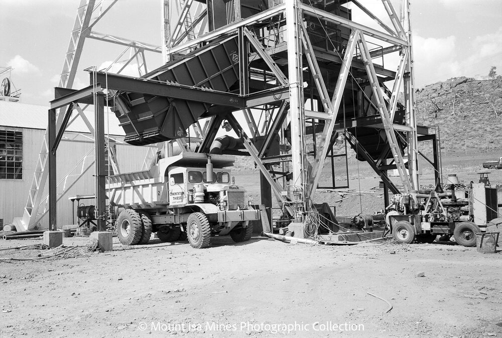 Euclid dump truck under mullock bin, Mount Isa Mines, February 1970