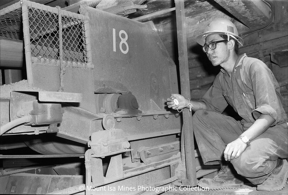 Technician checking a conveyor, Mount Isa Mines, January 1970