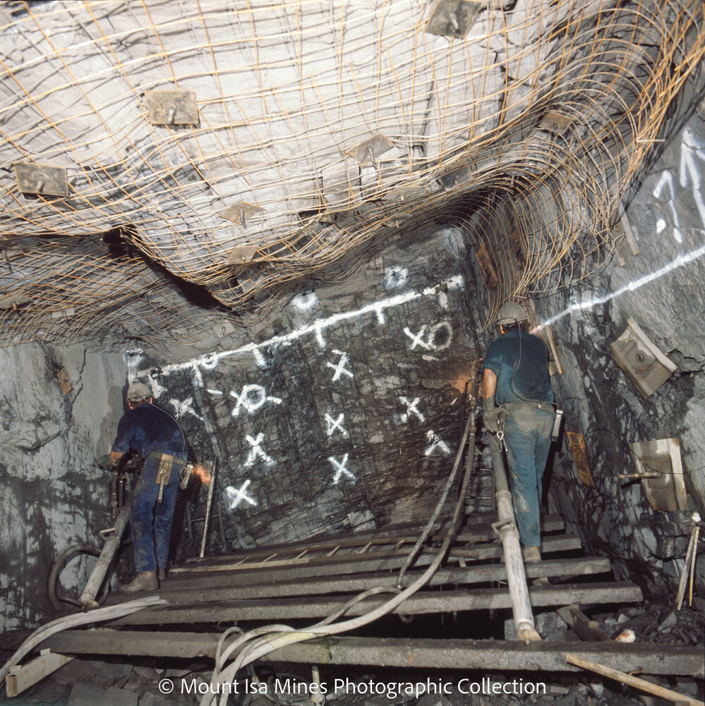 Flatbackers using airlegs to drill a face in MICAF lead mine, Mount Isa Mines, January 1987
