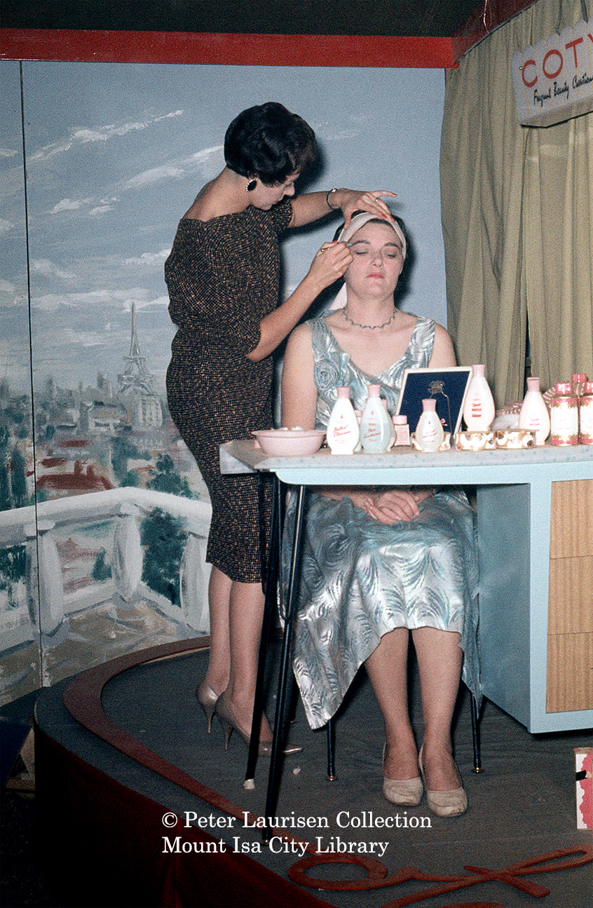 Woman getting make up, Mount Isa Industrial Fair, Spear Creek, June 1962