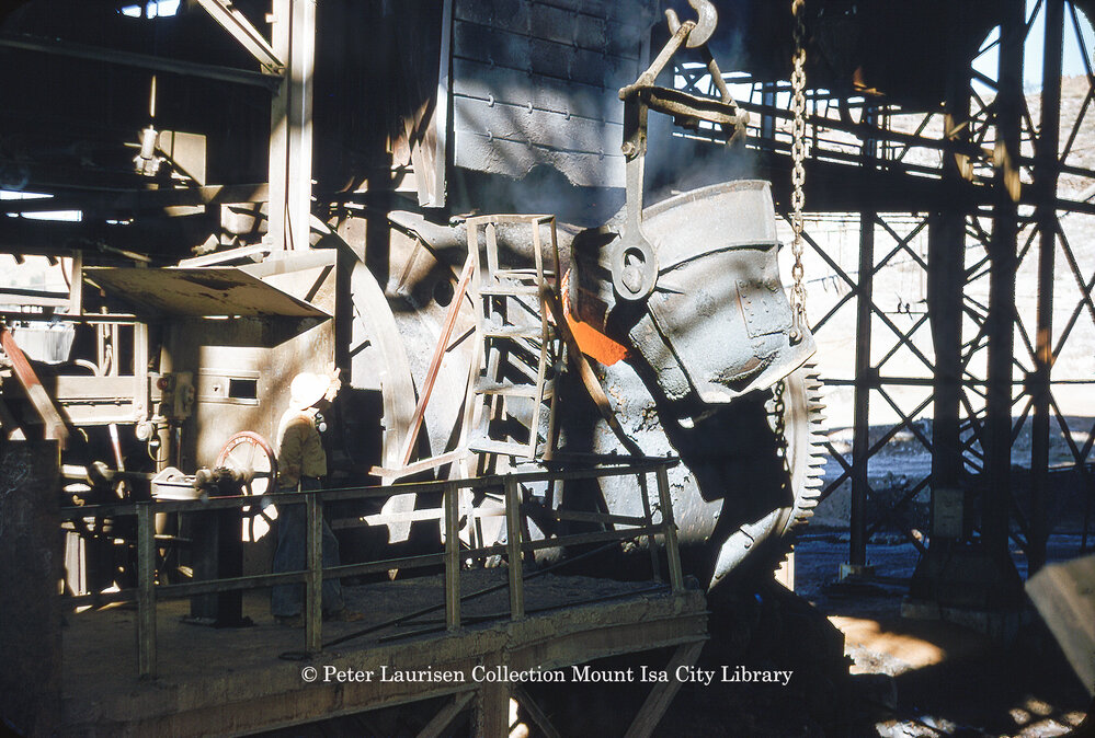 Charging converter with matte from reverberatory furnace at Copper Smelter, Mount Isa Mines, July 1956
