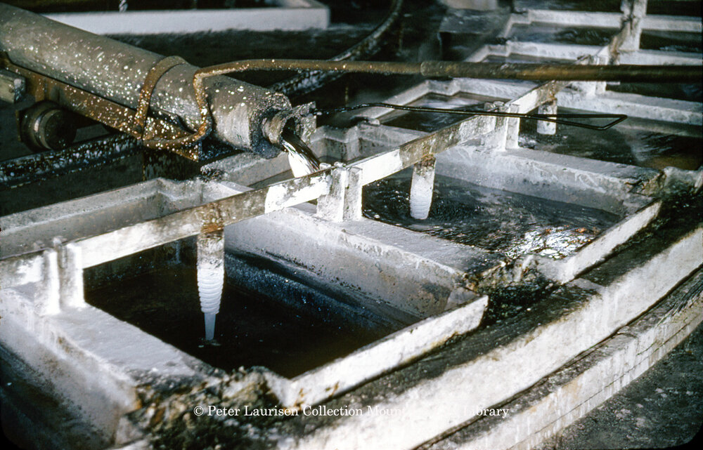Pouring molten lead into casting wheel moulds at Lead Smelter, Mount Isa Mines, July 1956