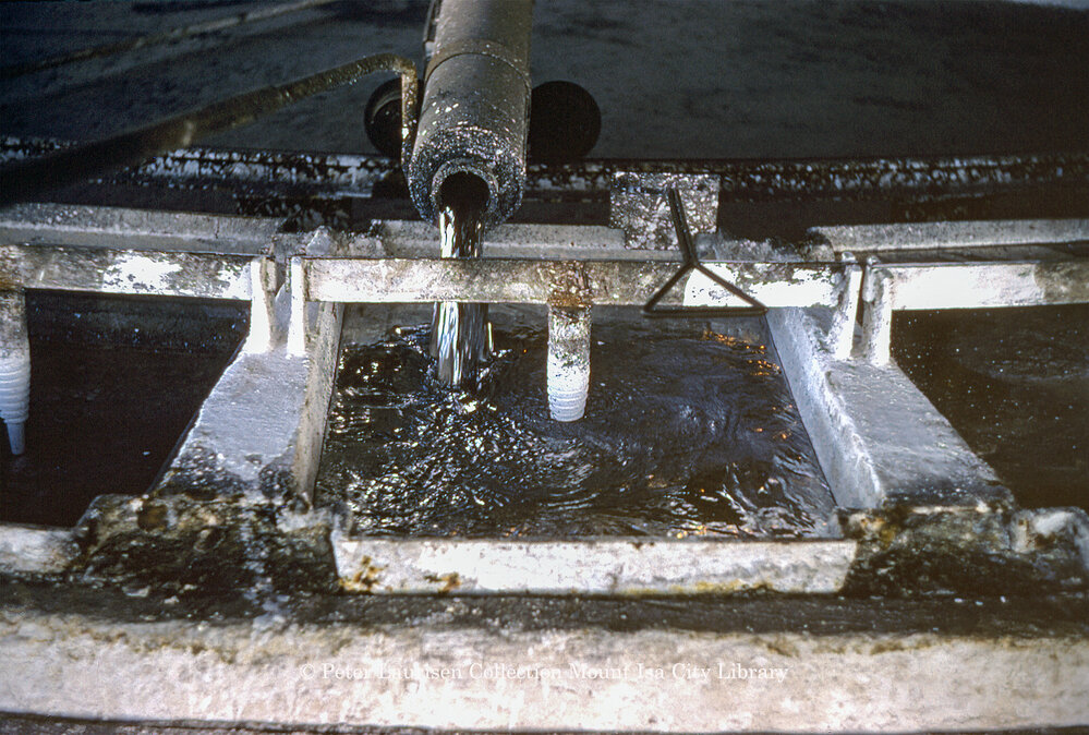Pouring molten lead into casting wheel moulds at Lead Smelter, Mount Isa Mines, July 1956