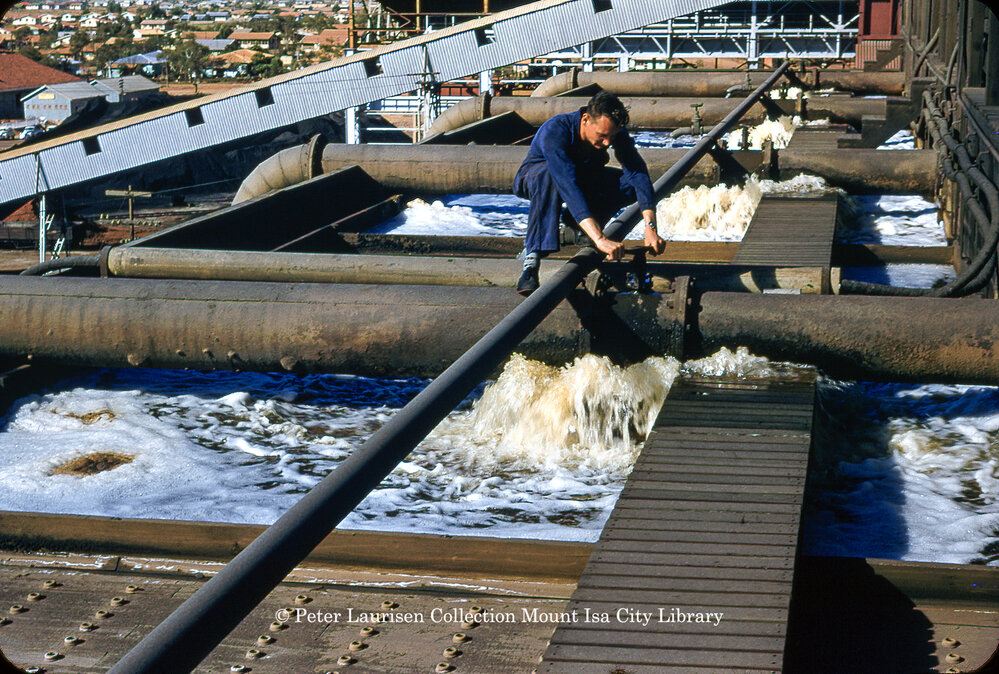 Engineer operating a valve in cooling tower at Mines Power Station, Mount Isa Mines, c.1956
