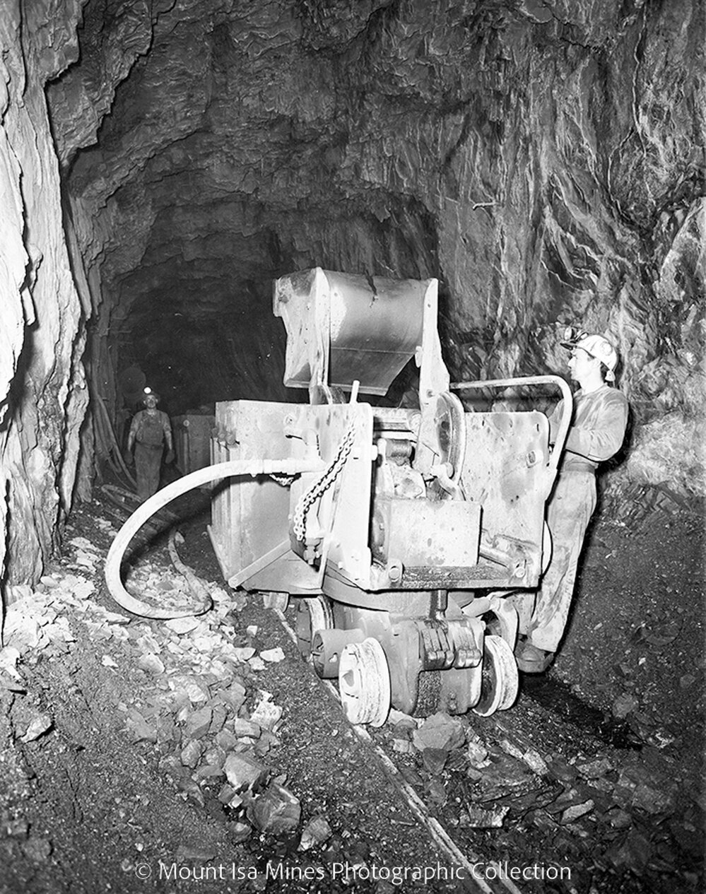 Loading gable car with rail mounted rocker shovel, Mount Isa Mines, May 1959