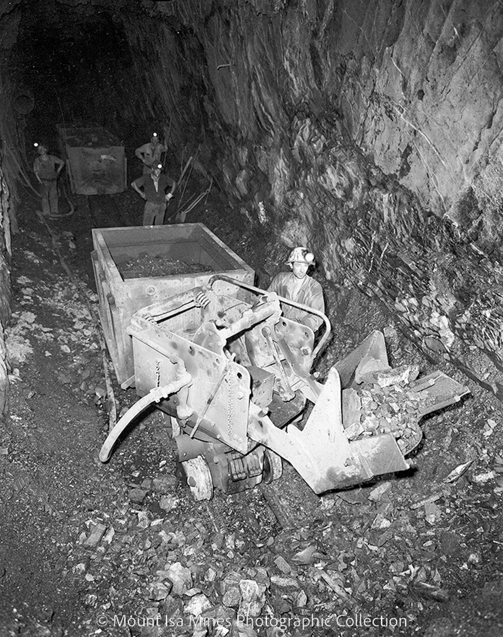 Loading a gable car with rail mounted rocker shovel, Mount Isa Mines, May 1959