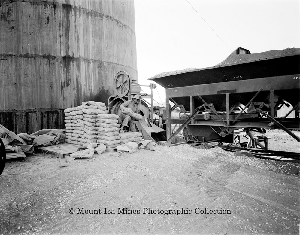 Concrete mixing at base of new Copper Stack, Mount Isa Mines, September 1959