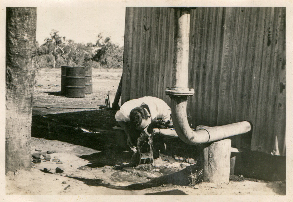 Man drinking water from No 1 bore, Soldiers Hill