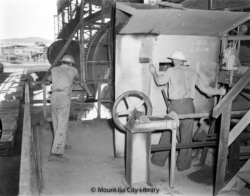 Skimming slag from converter at Copper Smelter, Mount Isa Mines, c.1956