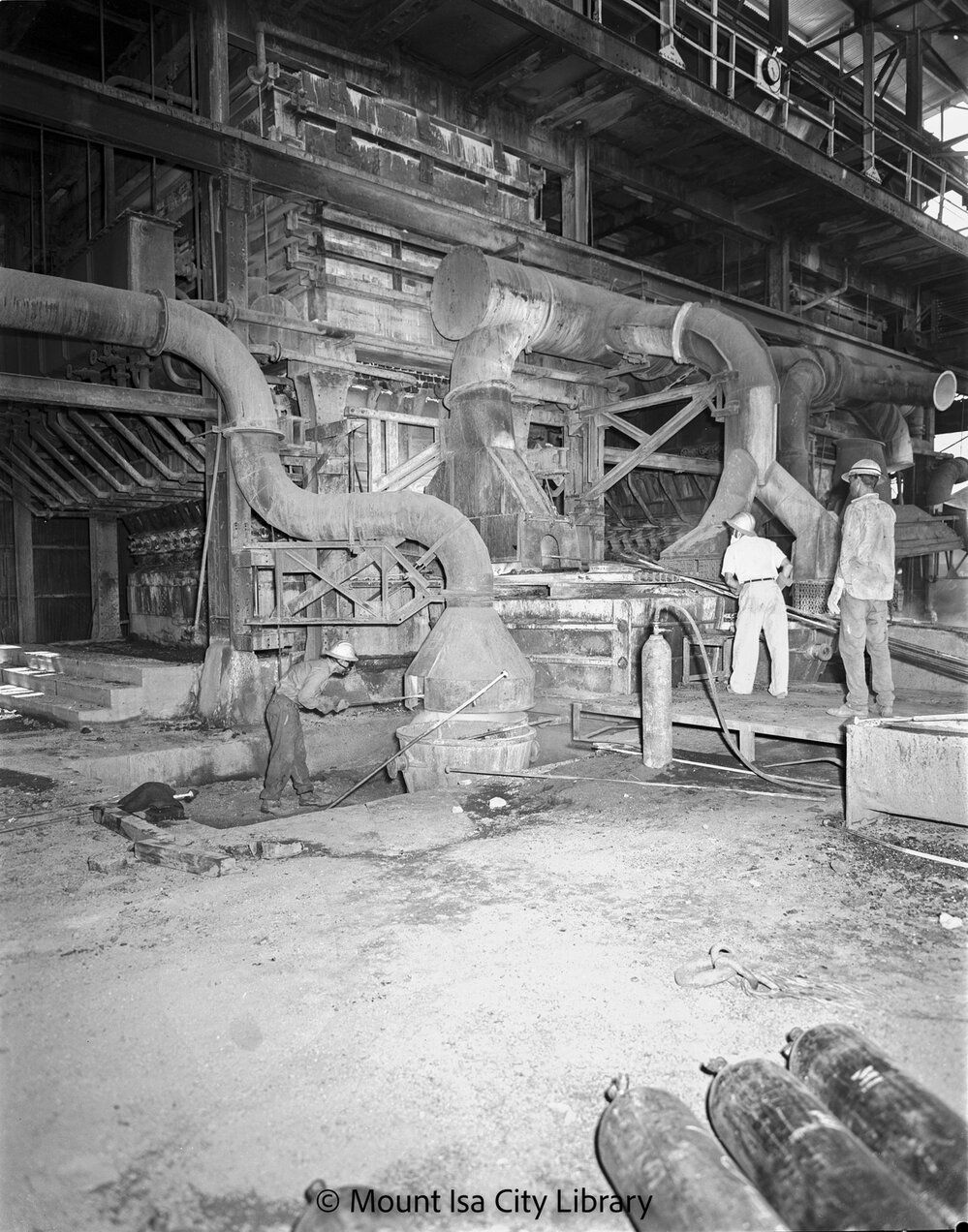 Tapping lead at Lead Smelter blast furnace, Mount Isa Mines, c.1956