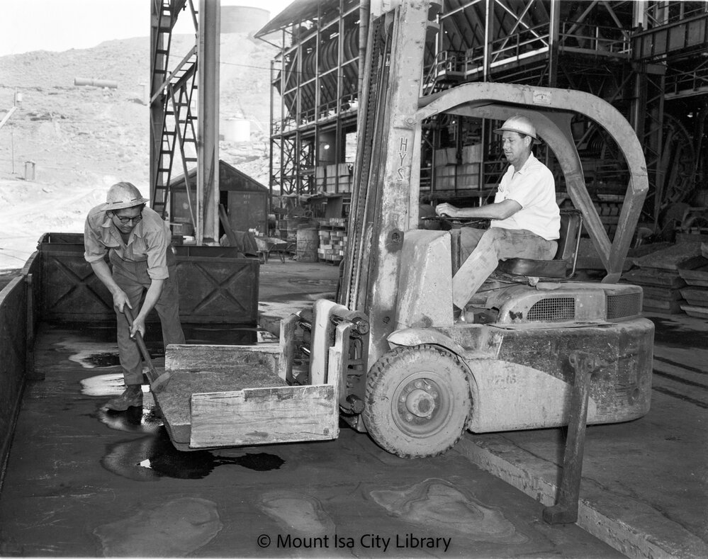 Loading blister copper blocks into railway wagons at Copper Smelter, Mount Isa Mines, c.1956