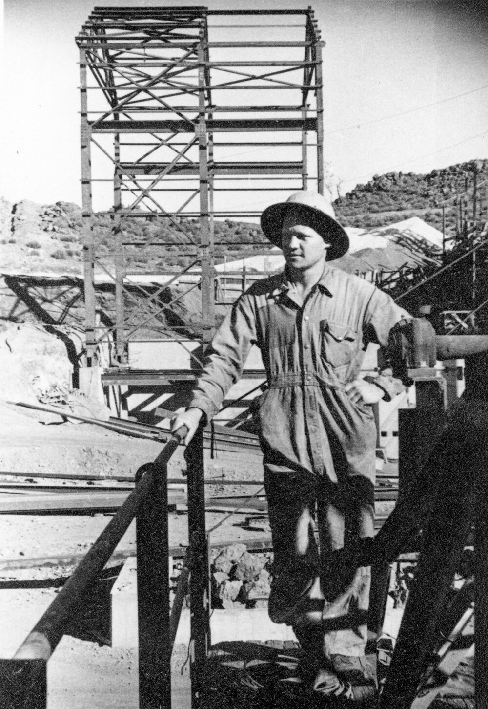 Peter Laurisen with new ore handling construction, Mount Isa Mines, c.1950