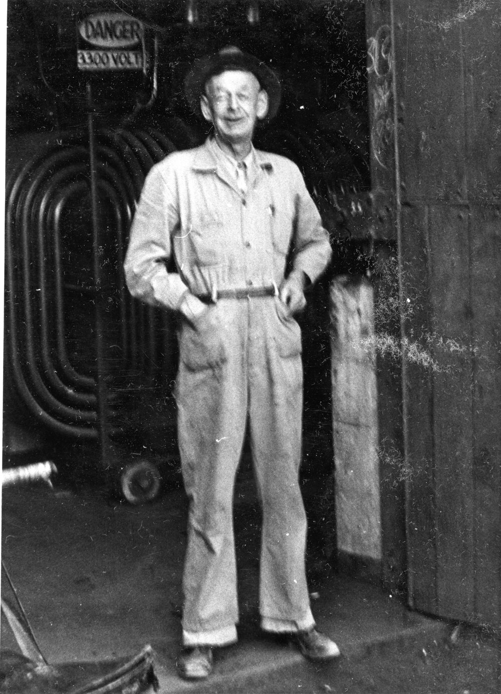 Man standing at Mill Substation, Mount Isa Mines, c.1950