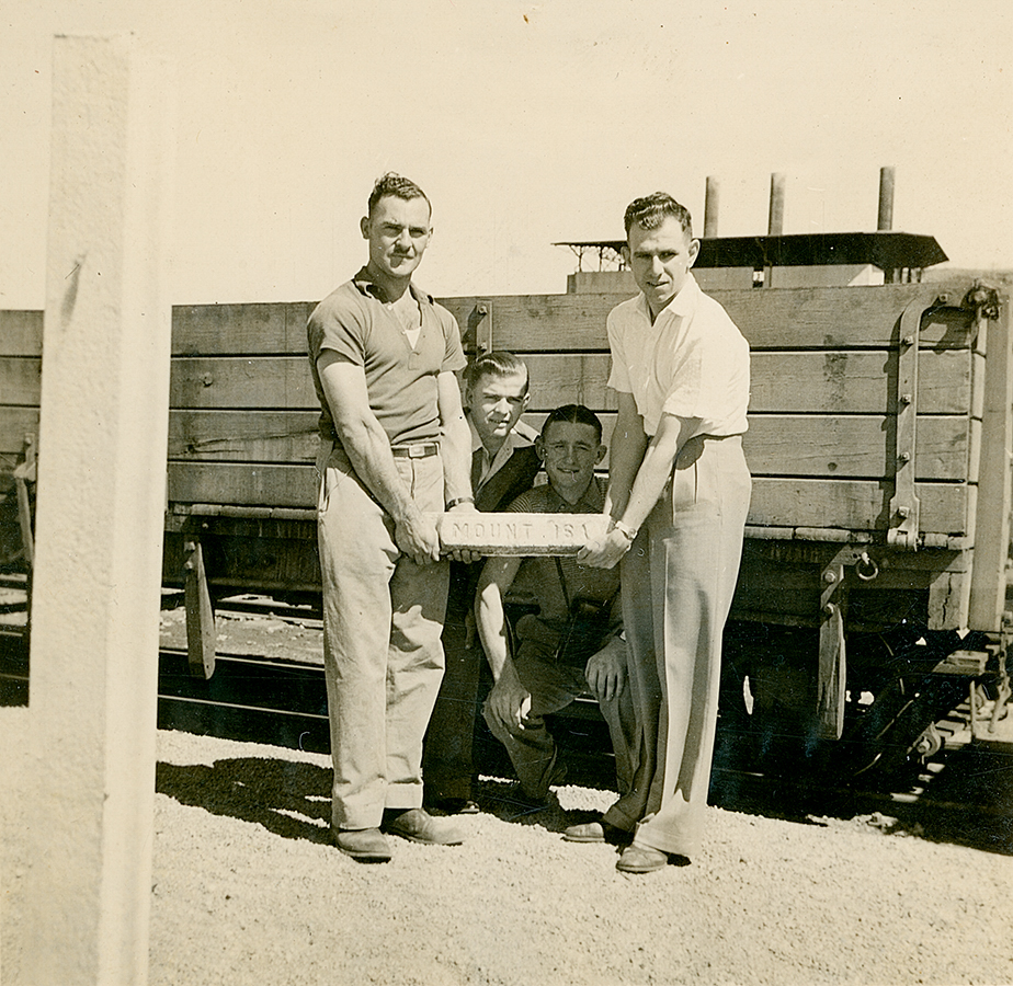 Four photographers at Mount Isa Railway Yards with a lead ingot 