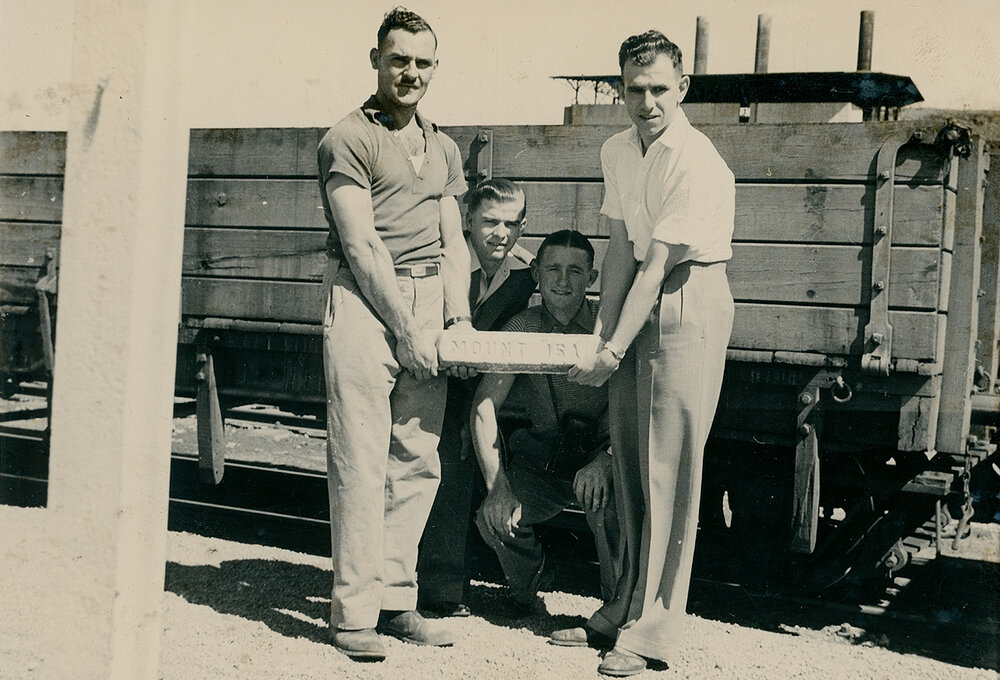 Group of photographers with ingot of lead