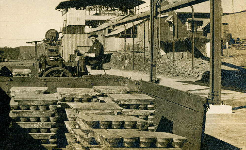 Loading lead ingots into railway wagon with electric lead buggy, Lead Smelter 