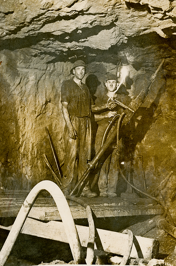 Two men at work on a machine, Mount Isa Mines