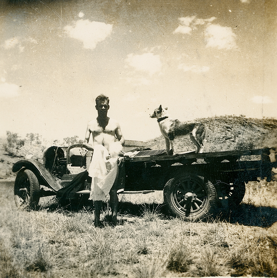 Man after a swim &amp; dog on a truck
