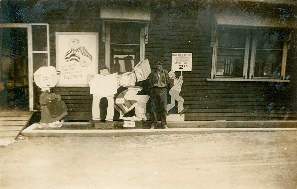 Man standing with first aid contest signs 