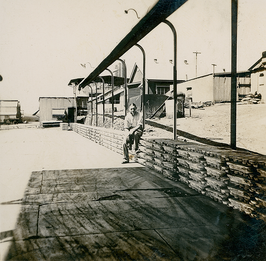 Norm Nancarrow sitting on lead ingots ready for transport to Townsville