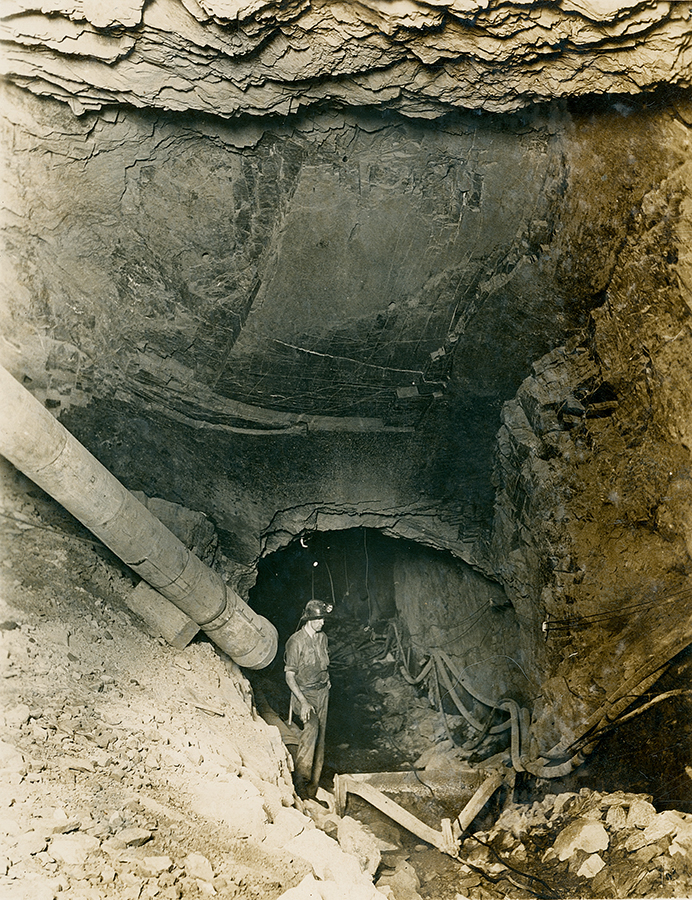 Scraper cleaning sump of No 1 Ore Shaft 5 Level underground, c.1948 