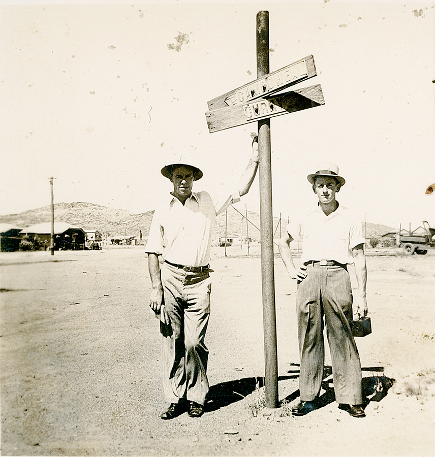 Two men at the Cloncurry and Camooweal sign, Mount Isa City