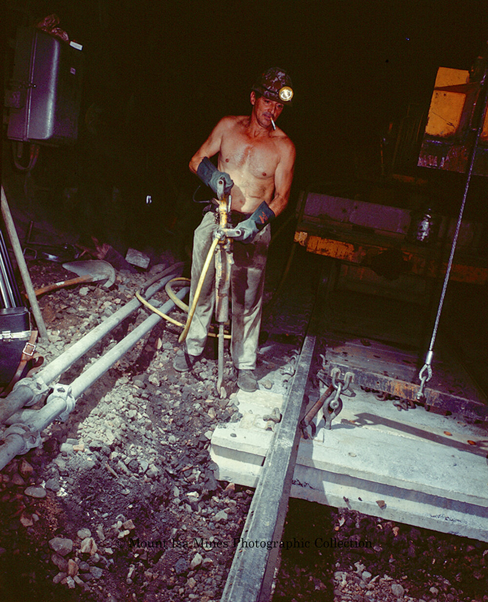 Workers laying concrete sleepers for underground haulage railway, Mount Isa Mines, March 1975