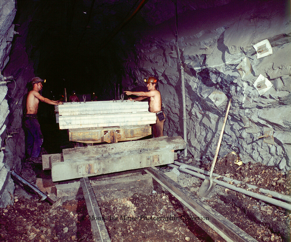 Workers laying concrete sleepers for underground haulage railway, Mount Isa Mines, March 1975