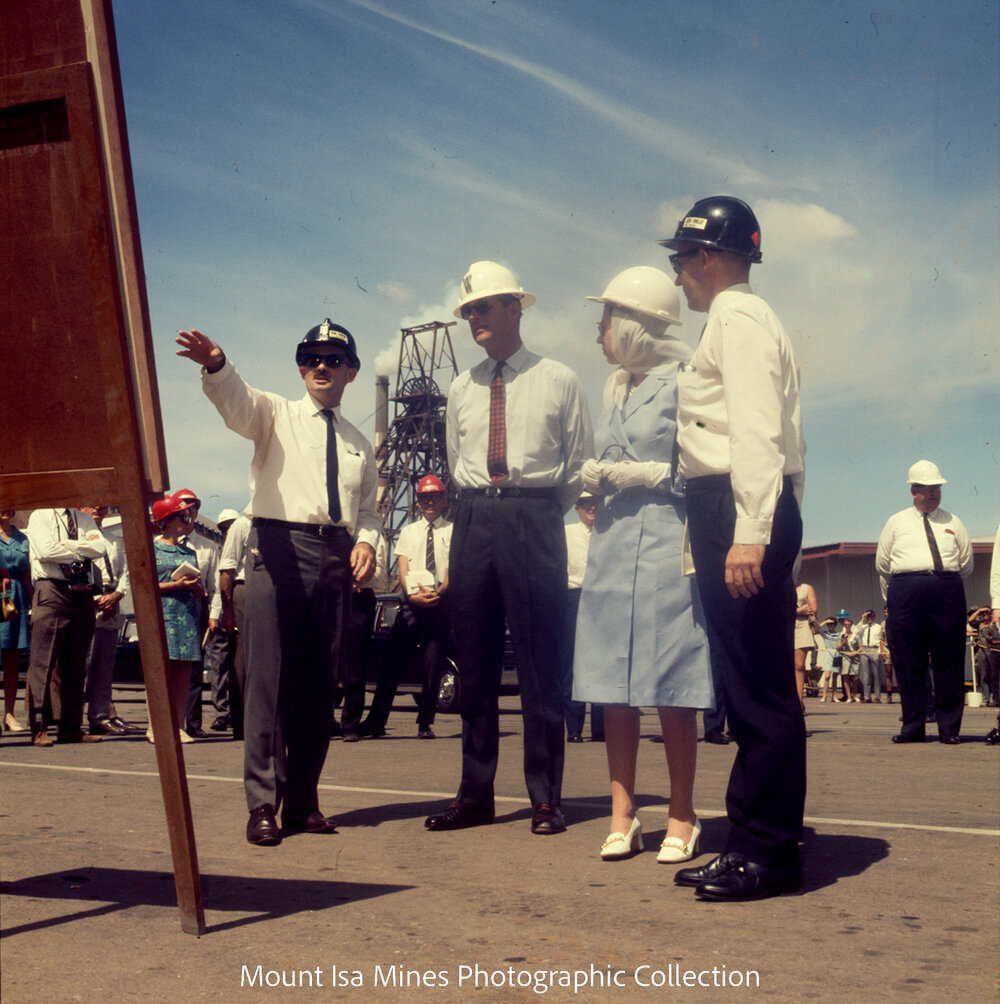 Queen Elizabeth II and Prince Philip view photograph of underground haulage operations, Mount Isa Mines, April 1970