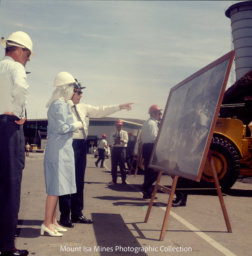 Queen Elizabeth II and Prince Philip view photograph of mine operations, Mount Isa Mines, April 1970