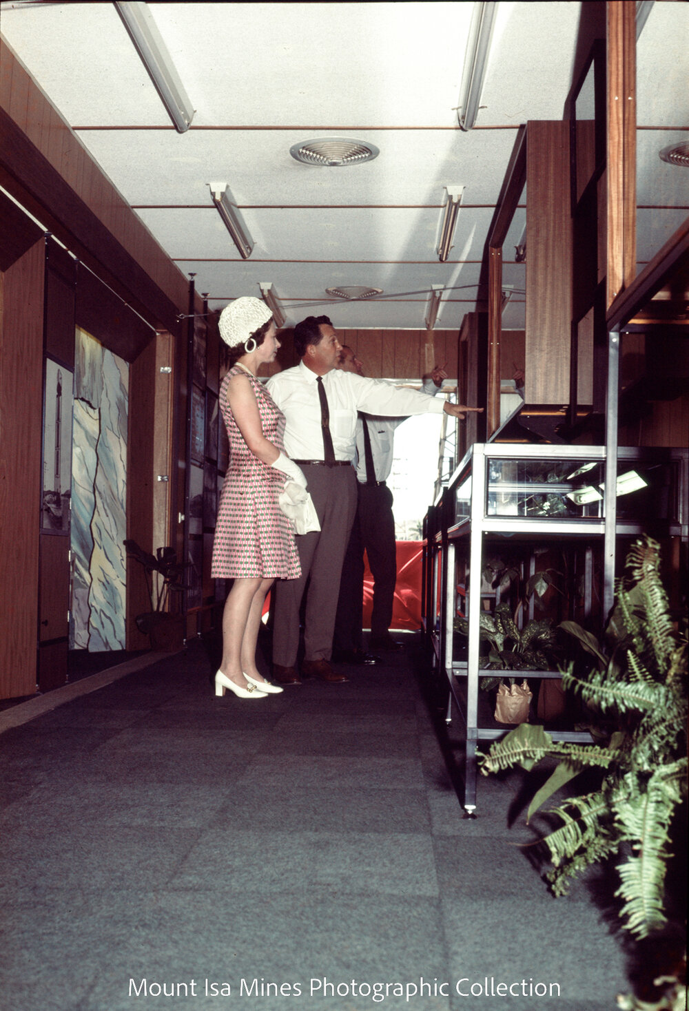 Queen Elizabeth II looks at display cabinets in Copper Smelter office, Mount Isa Mines, April 1970