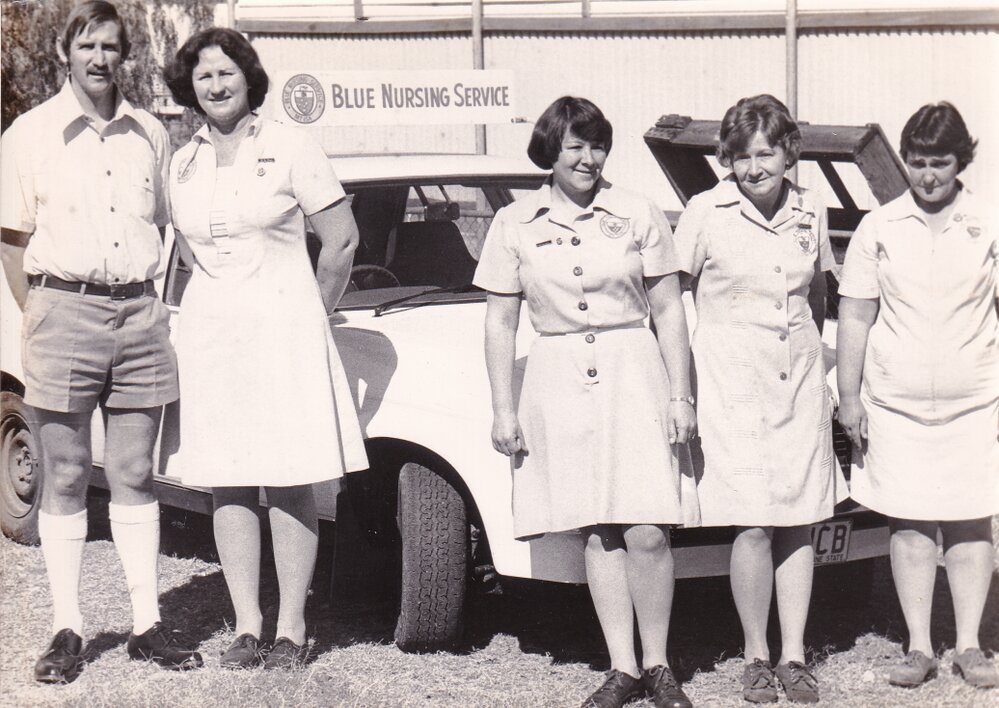 Blue Nursing Service staff in front of car