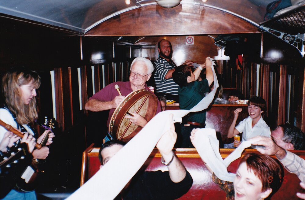Musicians and passengers on train, c.1998