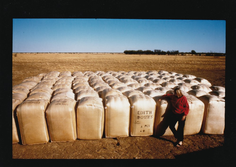 Edith Downs Station worker stands next to bagged material