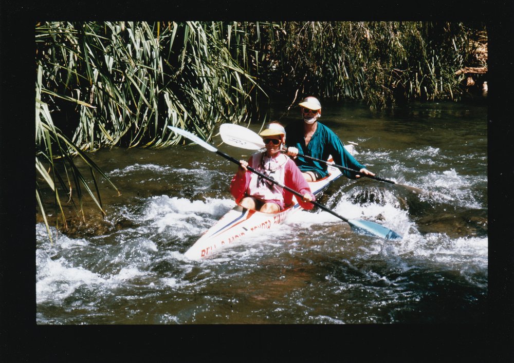 Couple kayaking in creek