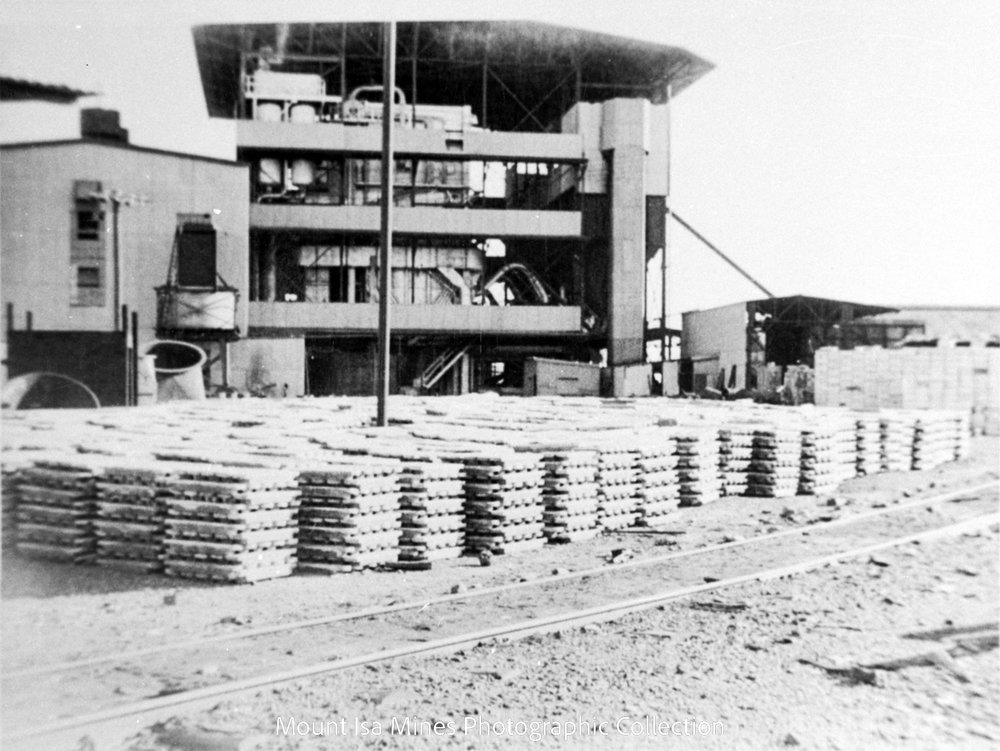 Stacked lead bars waiting for railway transport to Townsville, Mount Isa Mines, April 1964