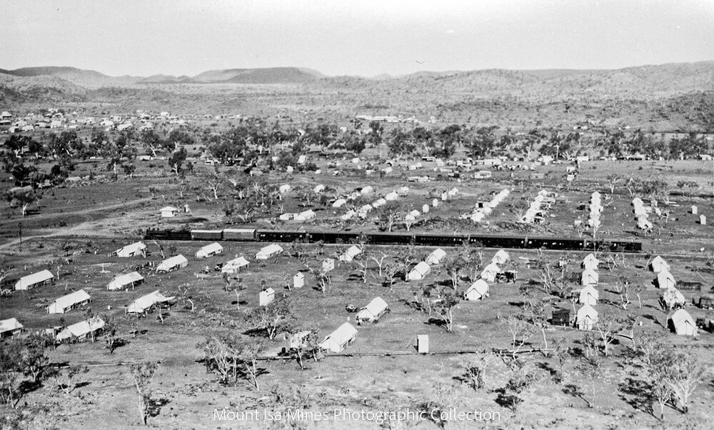 Train passing through tent city