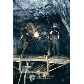 Underground rail mounted air leg drilling platform, Mount Isa Mines, c.1956