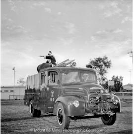 Santa arriving on Mount Isa Mines fire engine, Parkside, December 1958