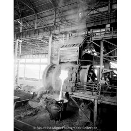Pouring molten copper into crane ladle from the converter at Copper Smelter, October 1958