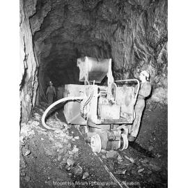 Loading gable car with rail mounted rocker shovel, Mount Isa Mines, May 1959