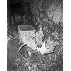 Loading a gable car with rail mounted rocker shovel, Mount Isa Mines, May 1959