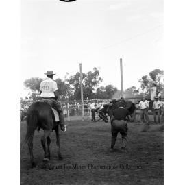 Mount Isa Rotary Rodeo Rough Riding, Spear Creek, September 1959