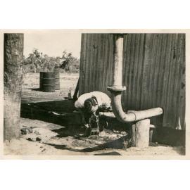 Man drinking water from No 1 bore, Soldiers Hill