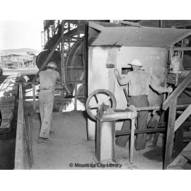 Skimming slag from converter at Copper Smelter, Mount Isa Mines, c.1956