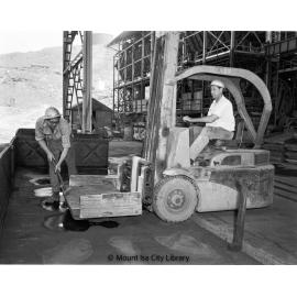Loading blister copper blocks into railway wagons at Copper Smelter, Mount Isa Mines, c.1956