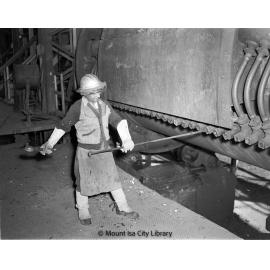 Punching tuyeres in converter at Copper Smelter, Mount Isa Mines, c.1956